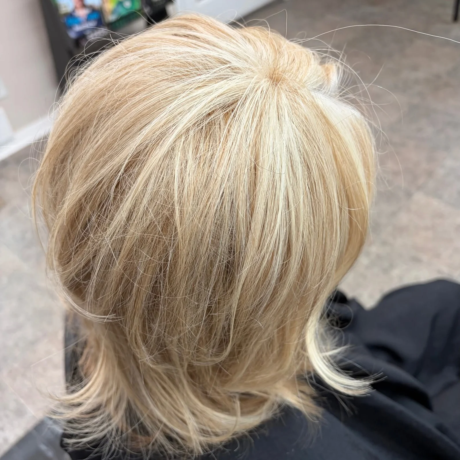 Blonde topper result with soft layers and natural crown coverage