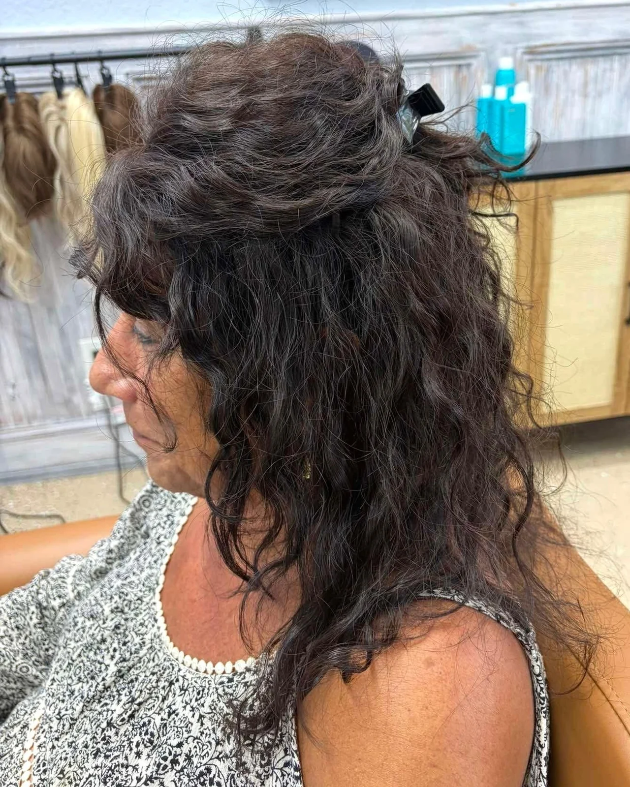 Client wearing a dark curly topper