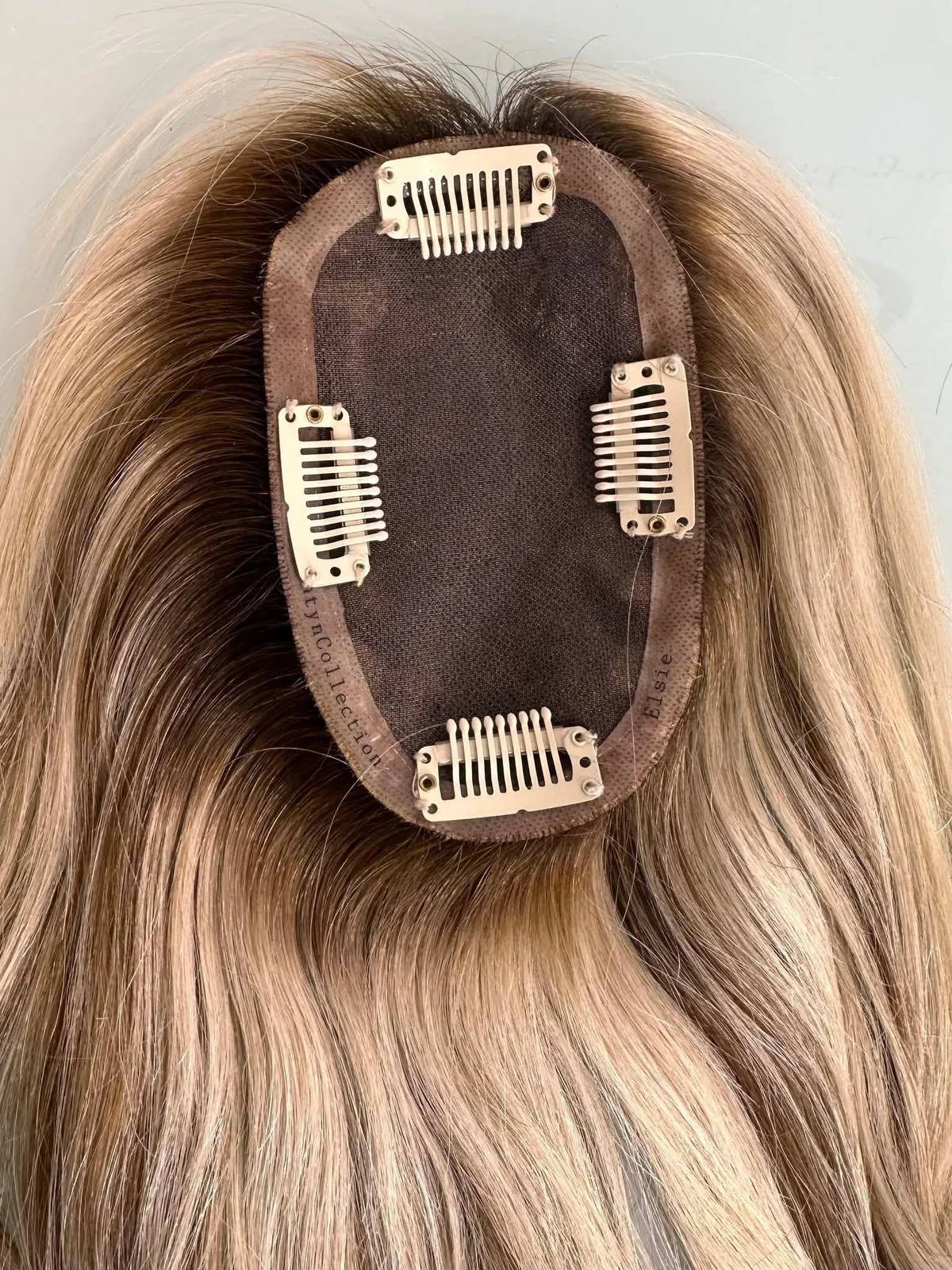 Inside of a hair topper showing the clip-in base